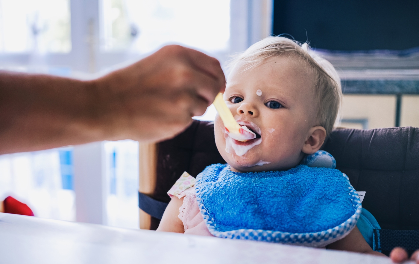Toddler eating yoghurt